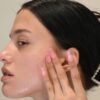 a woman with her hand on her face