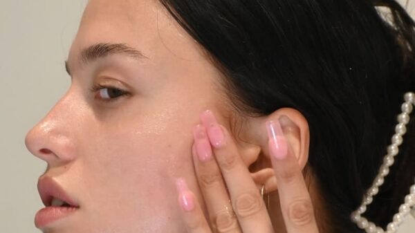 a woman with her hand on her face